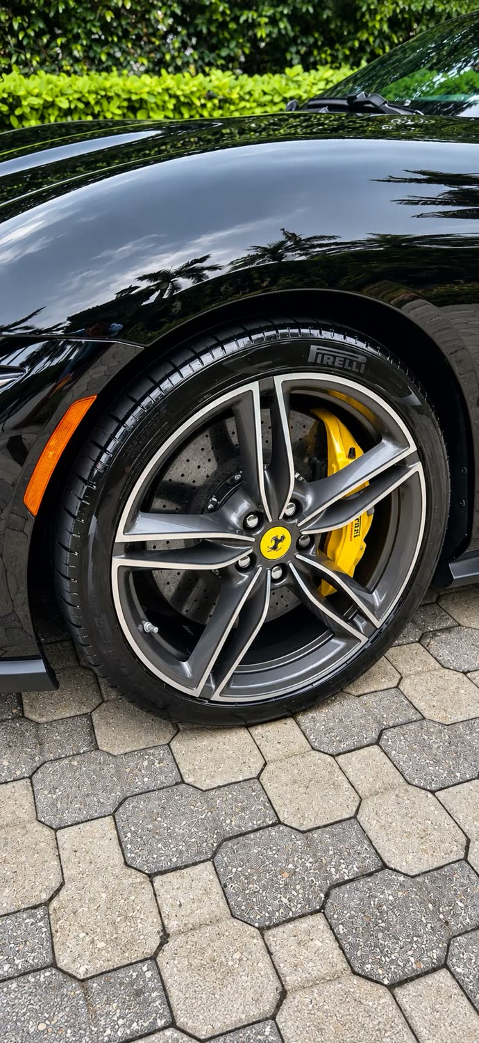 Ferrari wheel with yellow calipers and mirror-gloss black paint