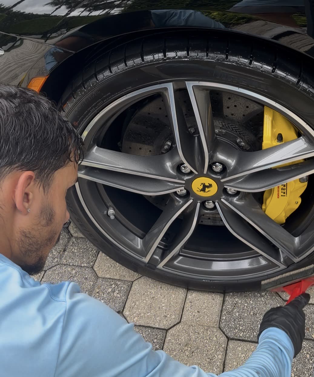 MDGA detailer cleaning a Ferrari wheel