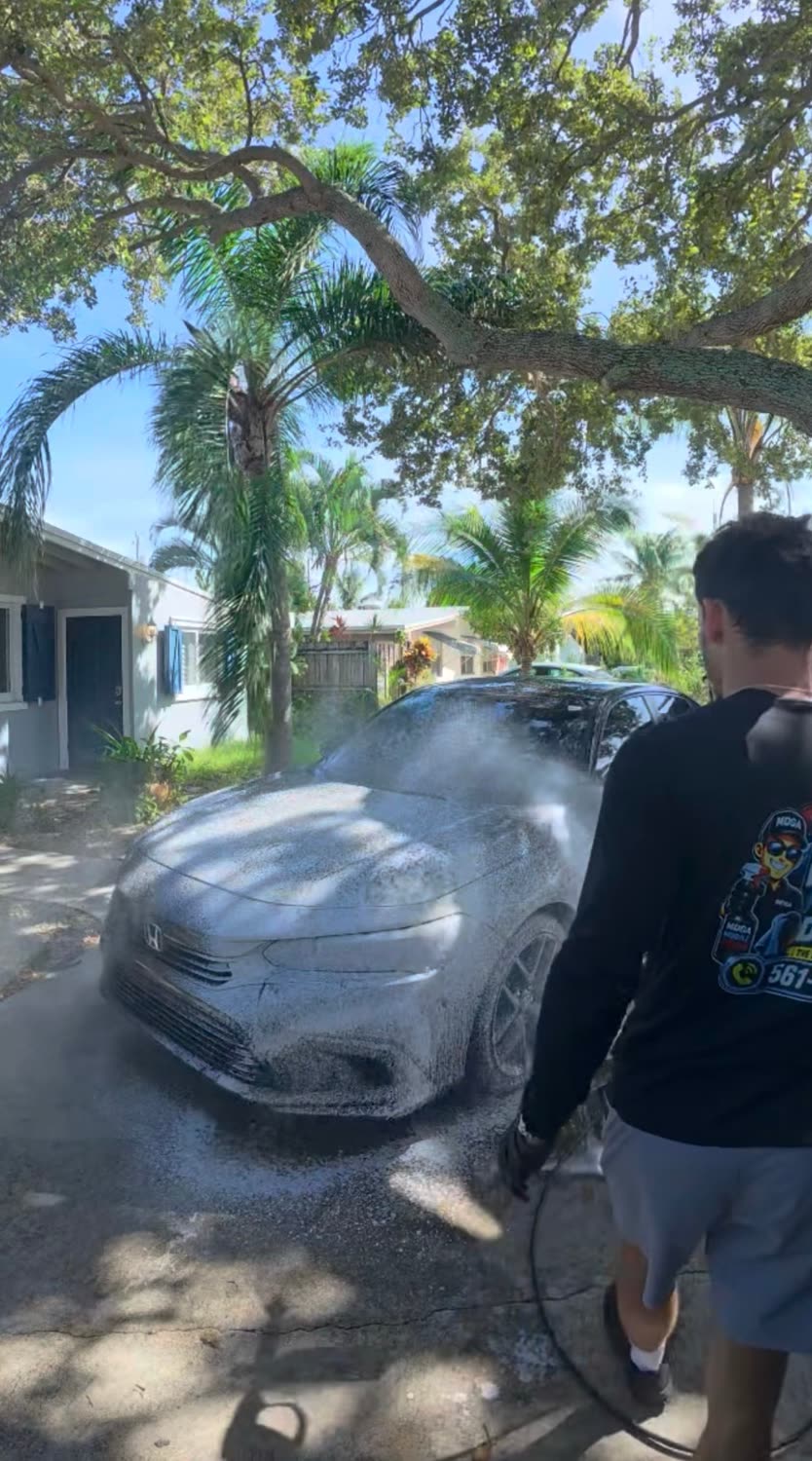 MDGA detailer rinsing snow foam off a Honda